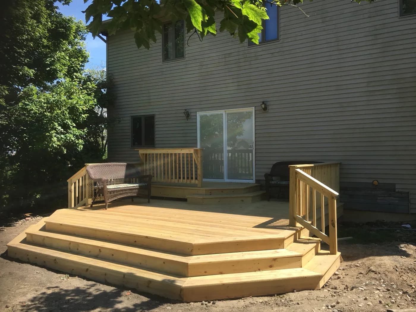 Freshly built cedar deck with railings and wide steps