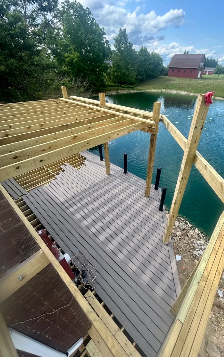 Dock and deck build in progress over a private lake