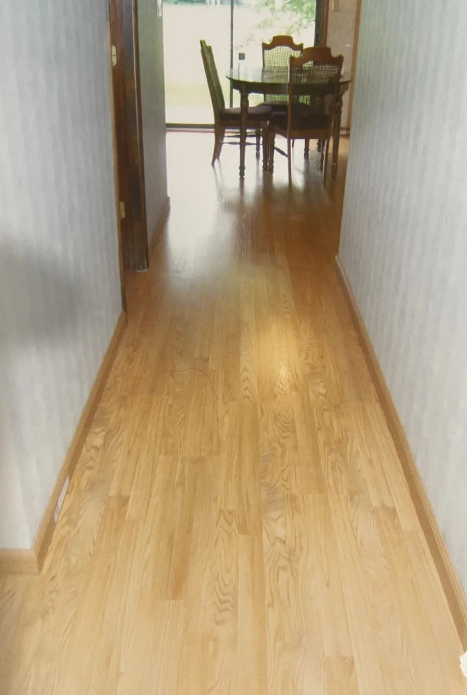 Refinished hardwood flooring in a residential hallway